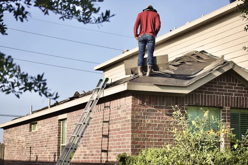 Professional roofer working on a residential roof in Poughquag